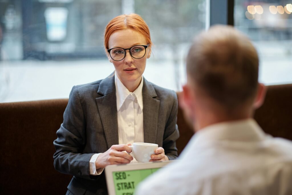 pexels-photo-5917717-5917717 Businesswoman having a corporate meeting with coffee in a casual setting.