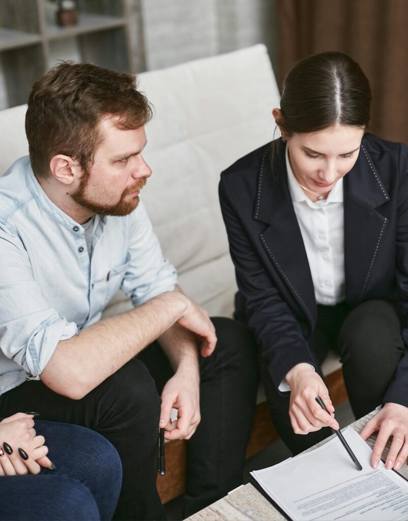 pexels-photo-7735691-7735691 Business professionals in a meeting reviewing significant documents in an office setting.